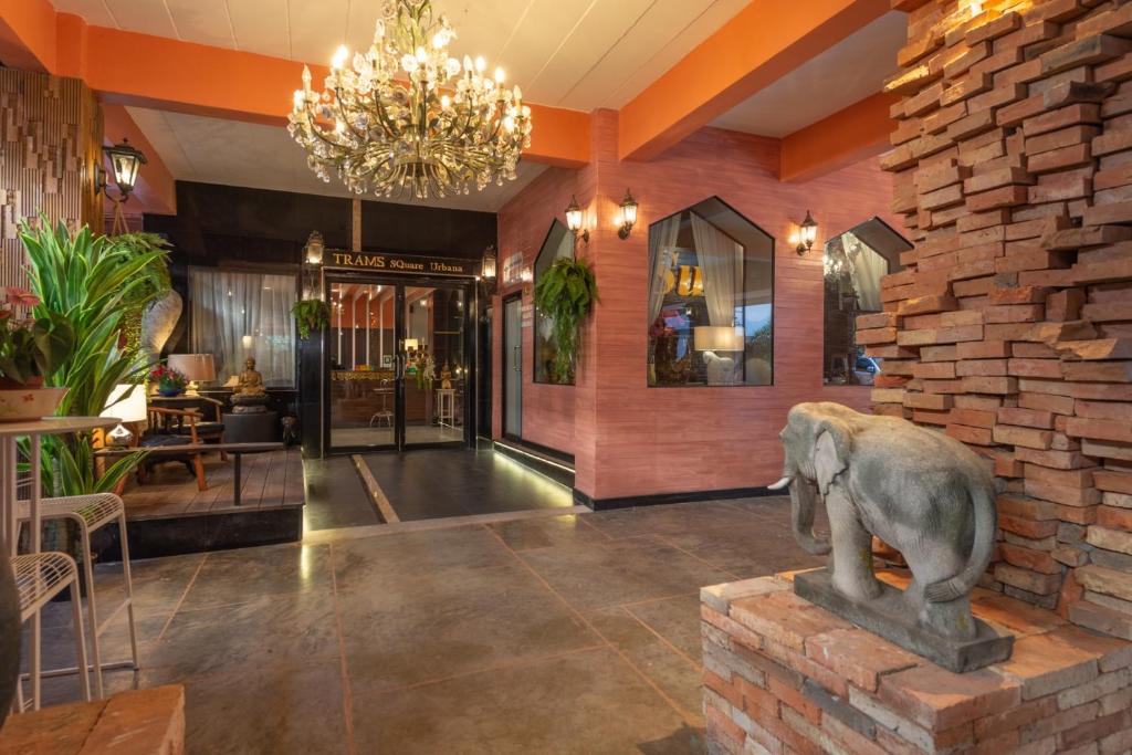 a lobby with a statue of an elephant on a brick wall at I-Inn Hotel in Bangkok
