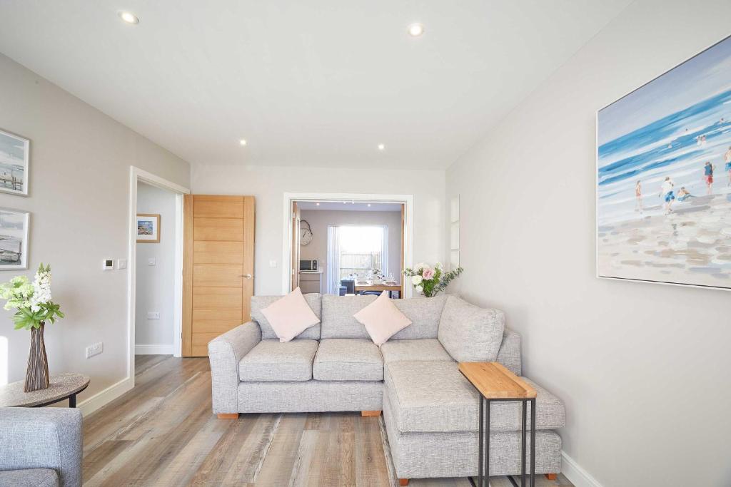 ein Wohnzimmer mit Sofa und Tisch in der Unterkunft Host & Stay - Sunflower Cottage in Seahouses