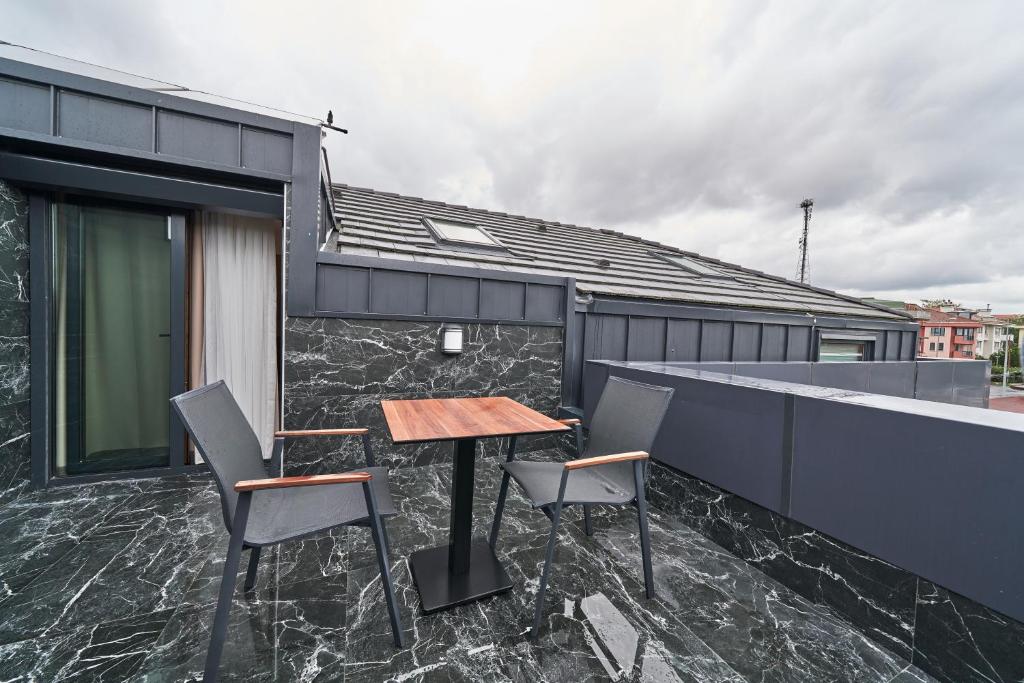 a table and chairs on the balcony of a house at Selini Hotel İstanbul Airport in Istanbul