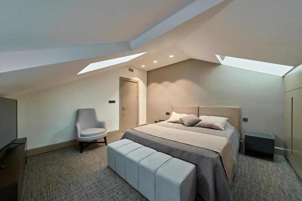 a bedroom with a large bed and a chair at Selini Hotel İstanbul Airport in Istanbul