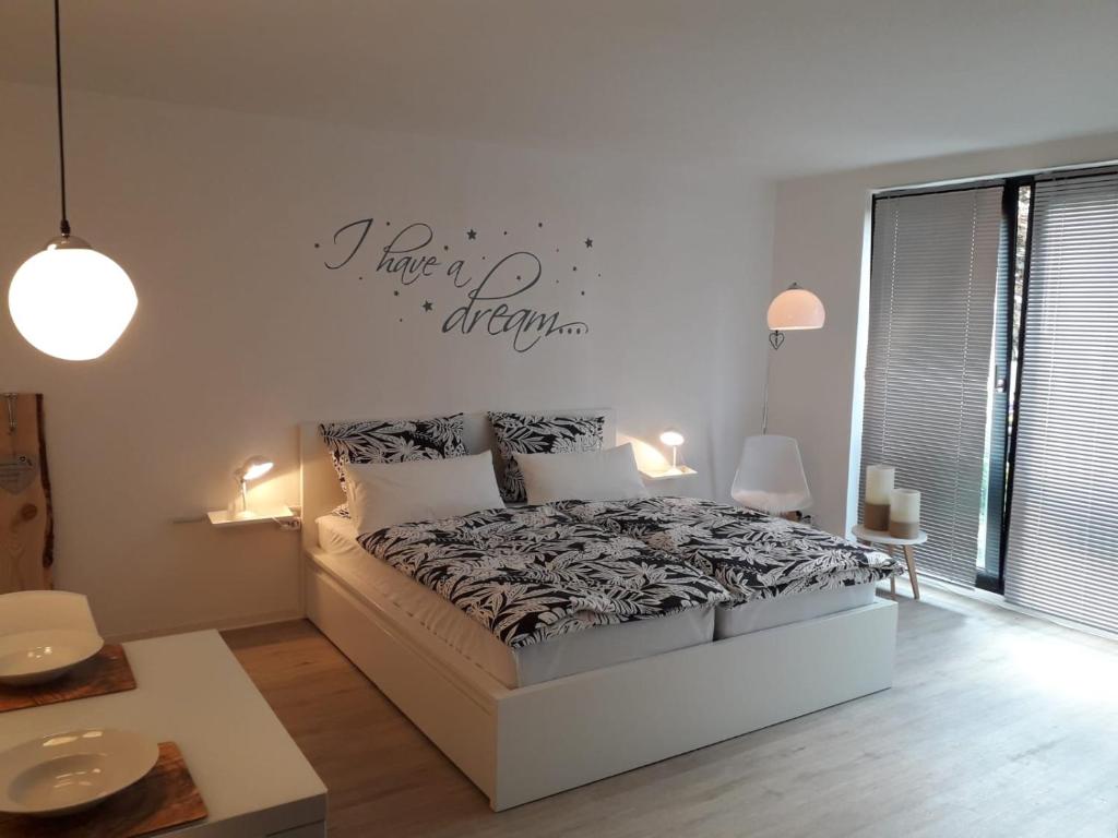1 dormitorio con 1 cama y un cartel en la pared en Moderne Ferienwohnung in Lippstadt Zentrum, en Lippstadt