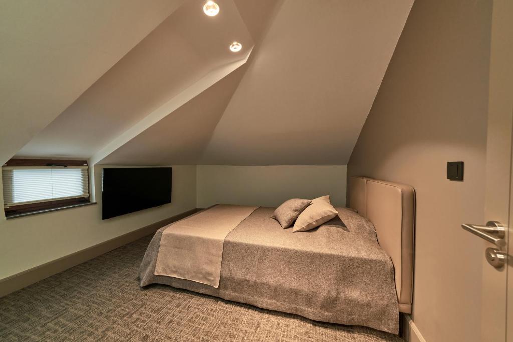 a bedroom with a bed and a flat screen tv at Selini Hotel İstanbul Airport in Istanbul