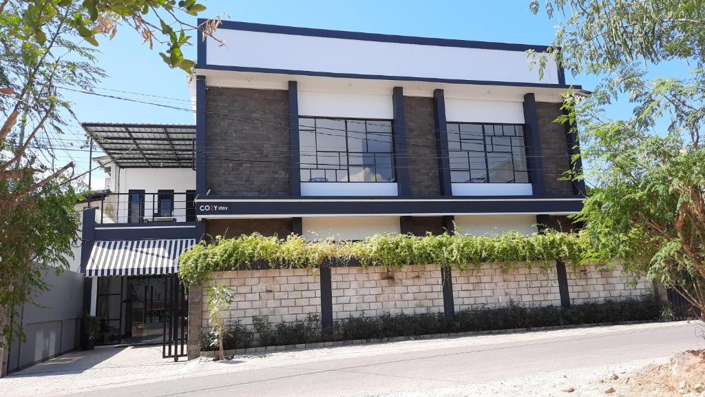 a building with a fence in front of it at COZY STAY KUPANG in Kupang