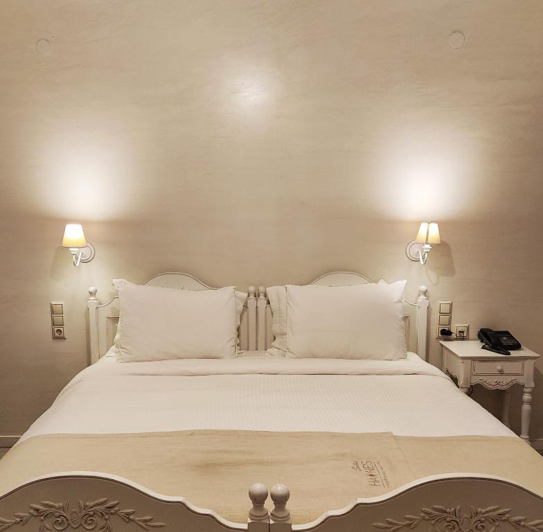 A bed or beds in a room at Haones Suites