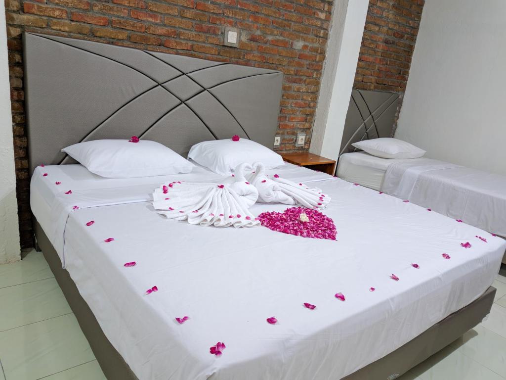 a bed with two beds with hearts on it at Griya Jagadhaya in Bantul