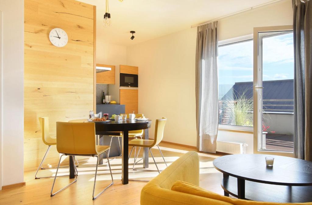 a dining room and living room with a table and chairs at Mountain Apartment Vrchlabi in Vrchlabí