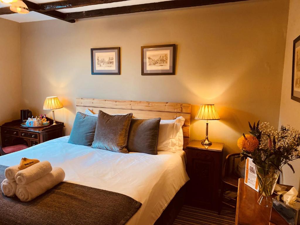 a bedroom with a bed with a teddy bear on it at Minster Walk Guesthouse in York