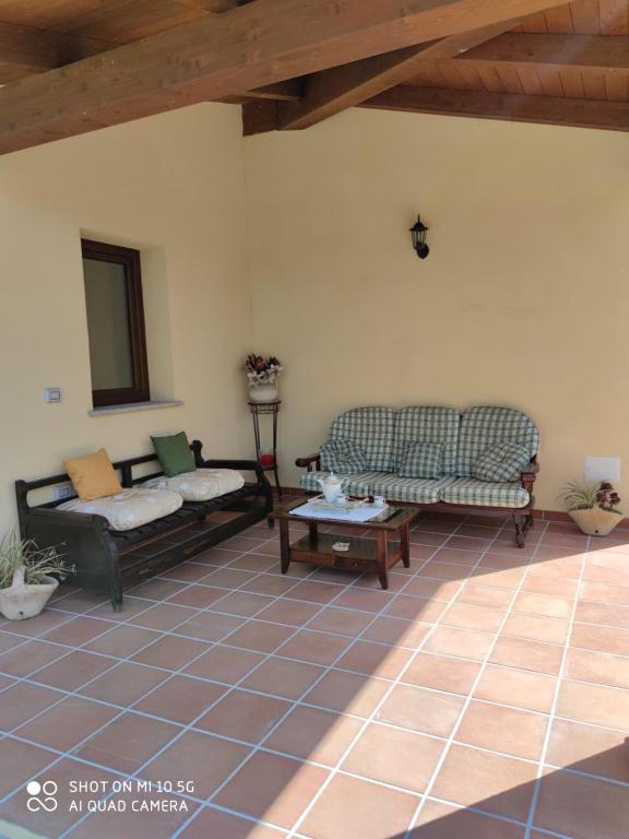 Sala de estar con 2 sofás y mesa en Casa di Roby 4L, en Marrùbiu