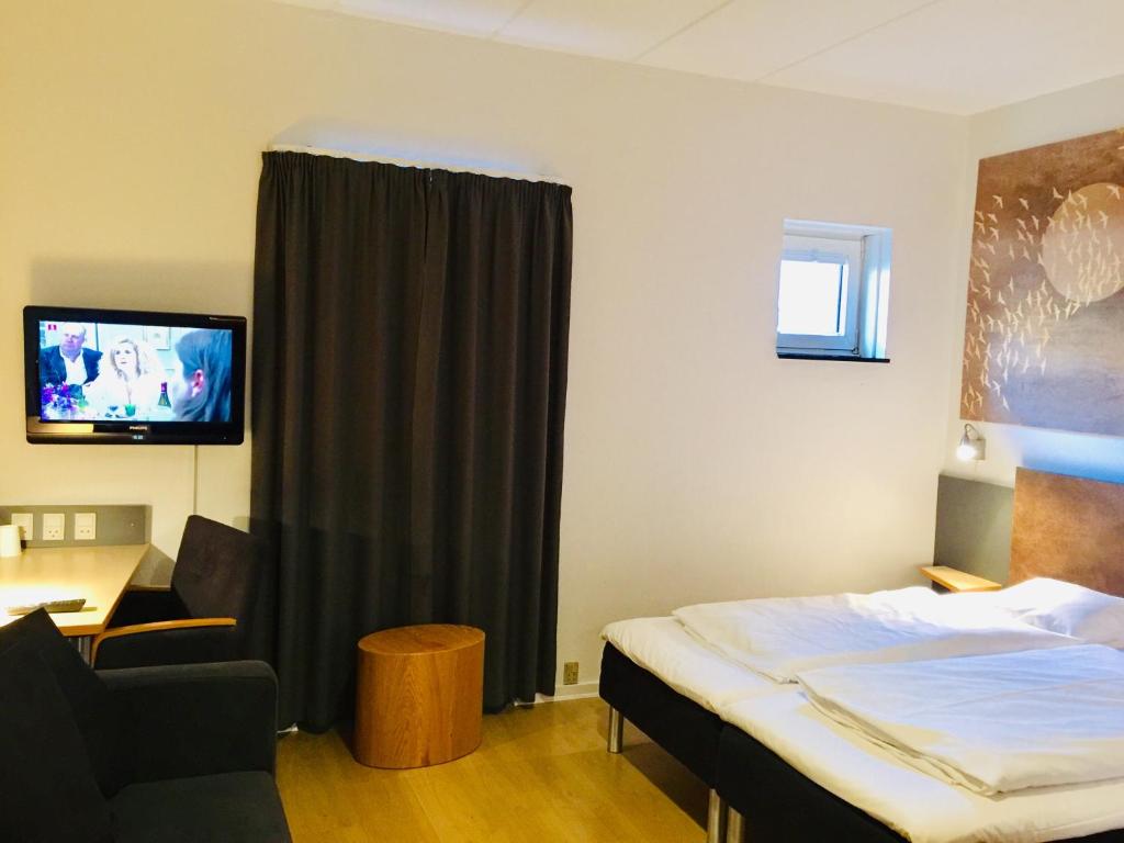 Postel nebo postele na pokoji v ubytování City Hotel Nattergalen