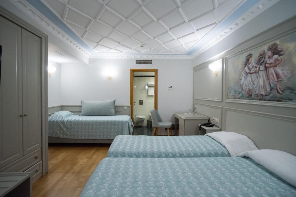 Postel nebo postele na pokoji v ubytování Byzantino Hotel