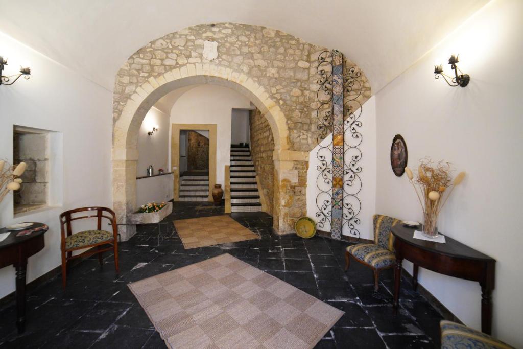 a hallway with an archway in a building at Baroque Modica in Modica