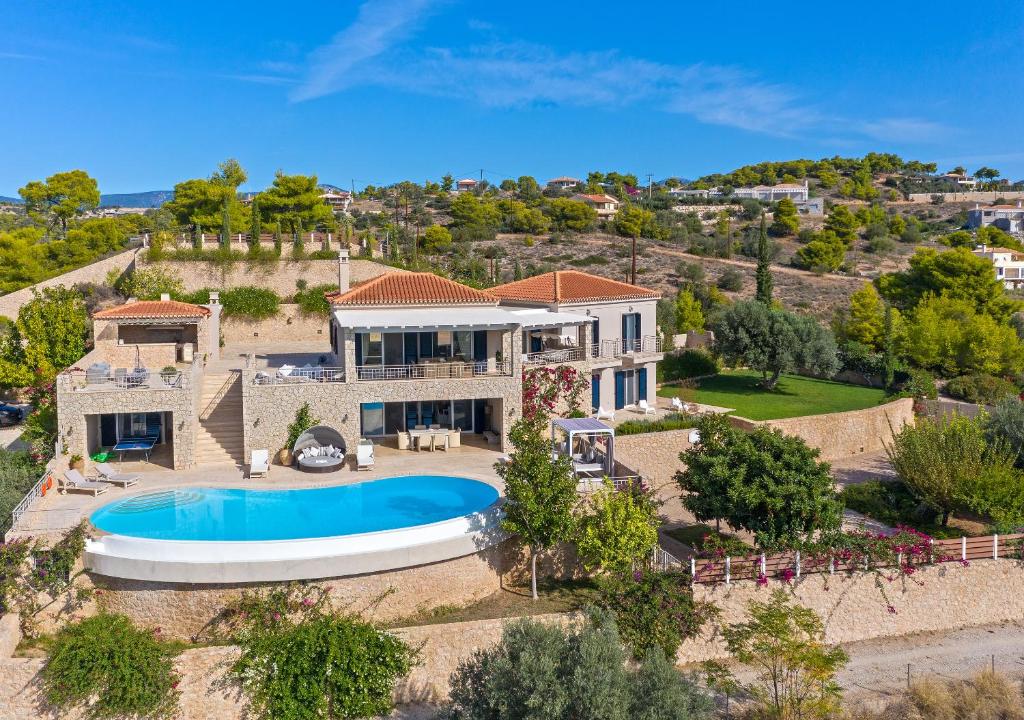 an aerial view of a house with a swimming pool at Angelico in Porto Heli