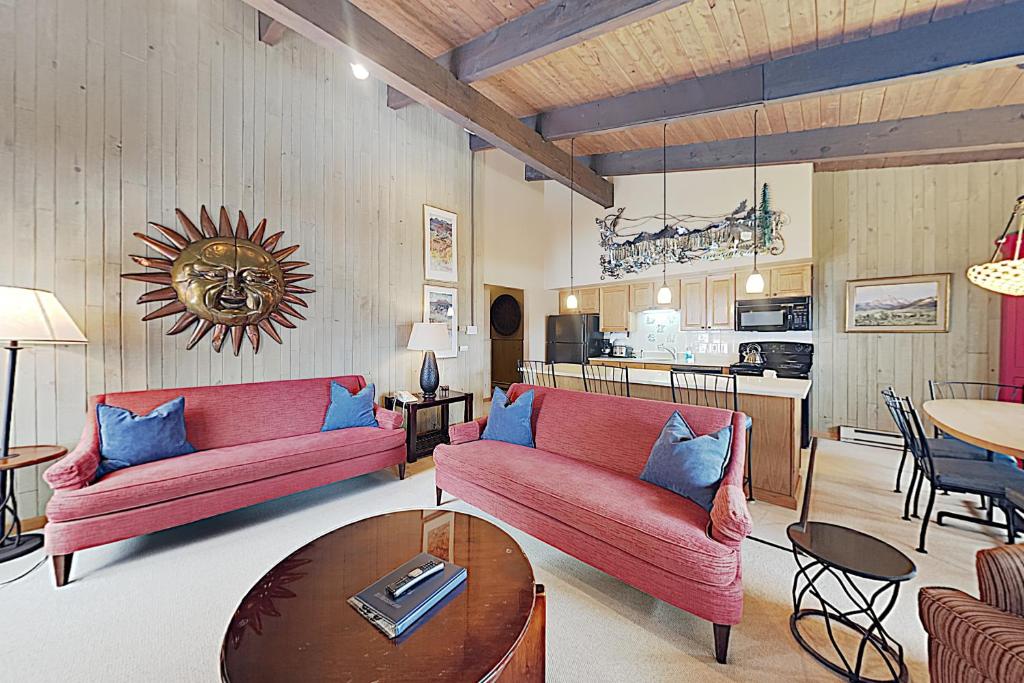 a living room with two red couches and a table at Timberline Condominiums 3 Bedroom Standard Unit D3A in Snowmass Village