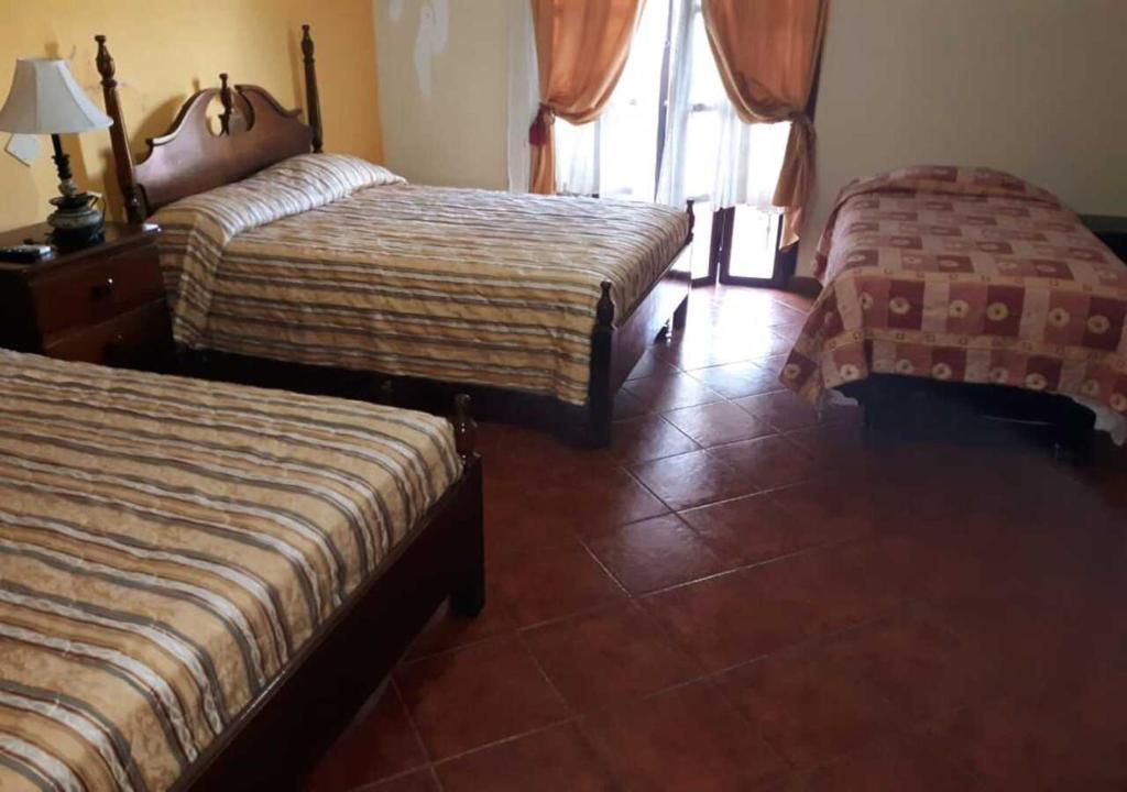 Voodi või voodid majutusasutuse Hotel Acropolis Maya toas