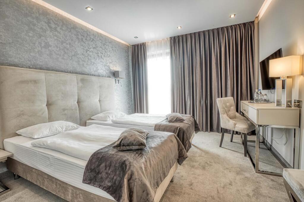 Postel nebo postele na pokoji v ubytování Hotel Biały Dom