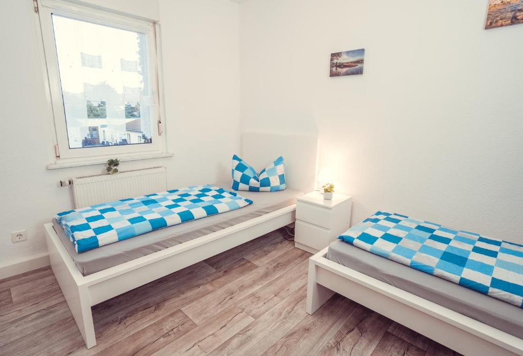 Postel nebo postele na pokoji v ubytování Auberge Leipzig