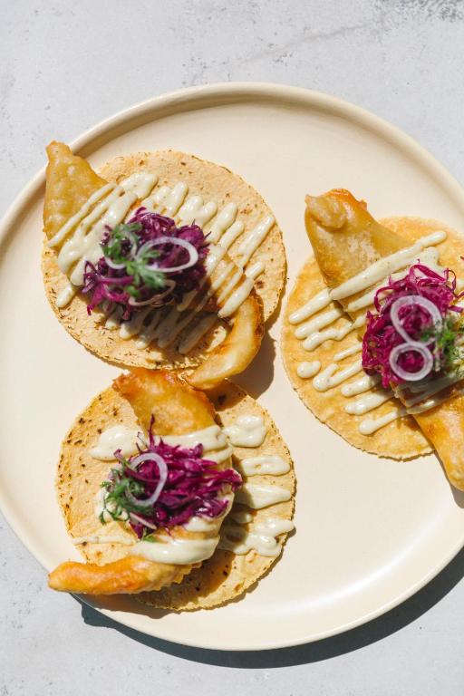 a plate of food with sandwiches on a table at Brick Hotel Mexico City - Small Luxury Hotels of the World in Mexico City