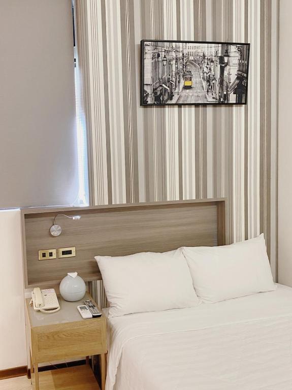 Postel nebo postele na pokoji v ubytování H Hotel