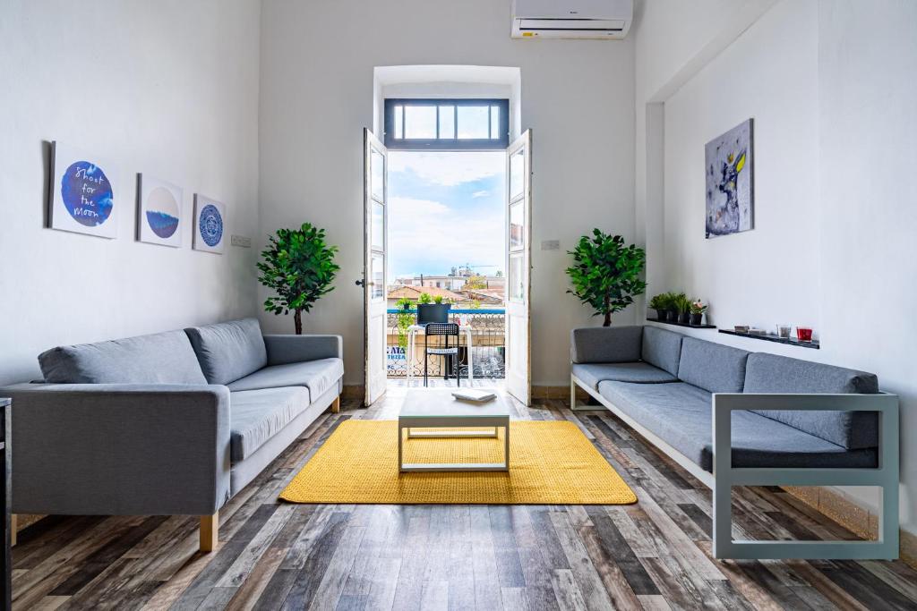 a living room with two couches and a table at Bee Hostel in Limassol