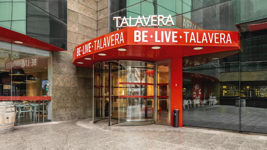 a building with a sign that reads take initiative be live takezona at Be Live City Center Talavera in Talavera de la Reina