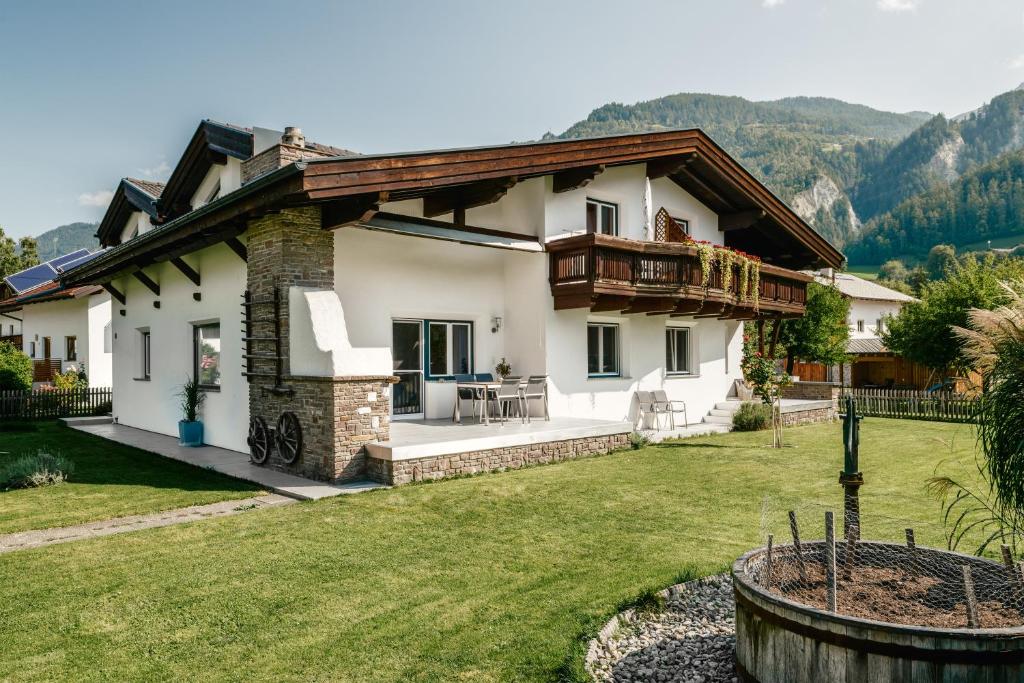 a house in the mountains with a yard at Active Apart Central in Ried im Oberinntal