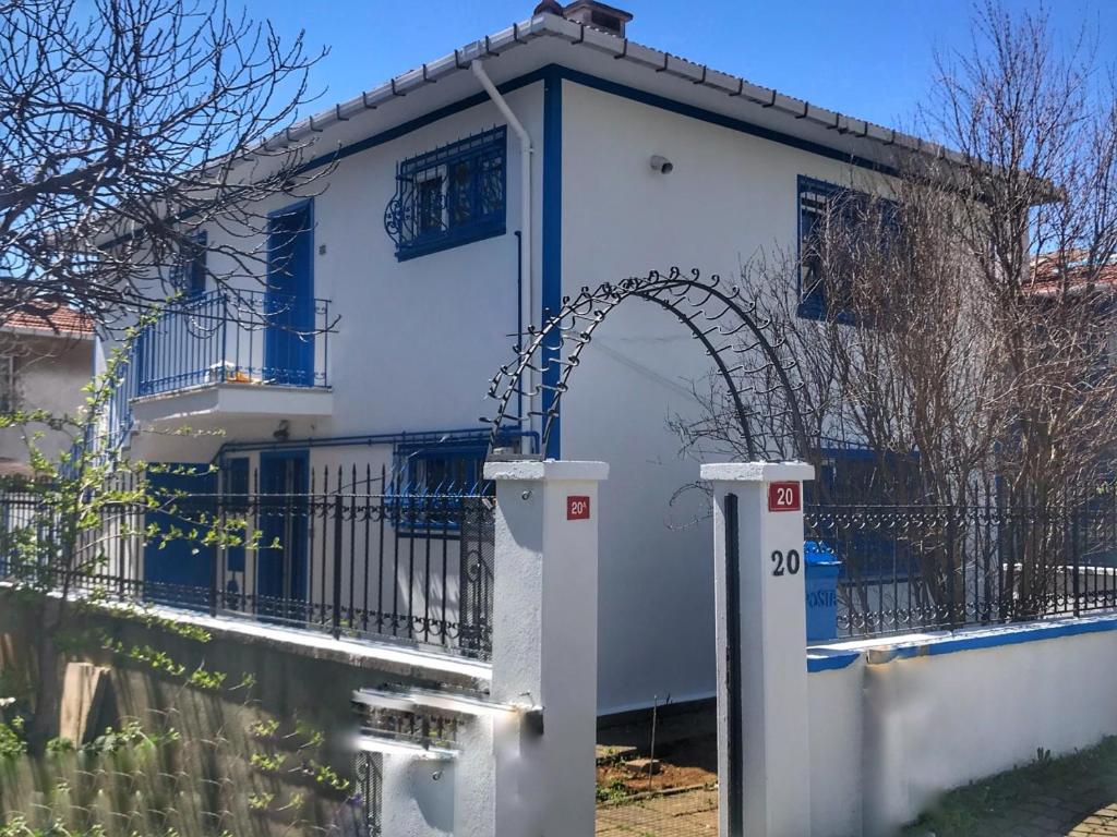 a white house with an arch in front of a fence at 5 Star luxury Private Detached House & Private Garden & BBQ in Istanbul