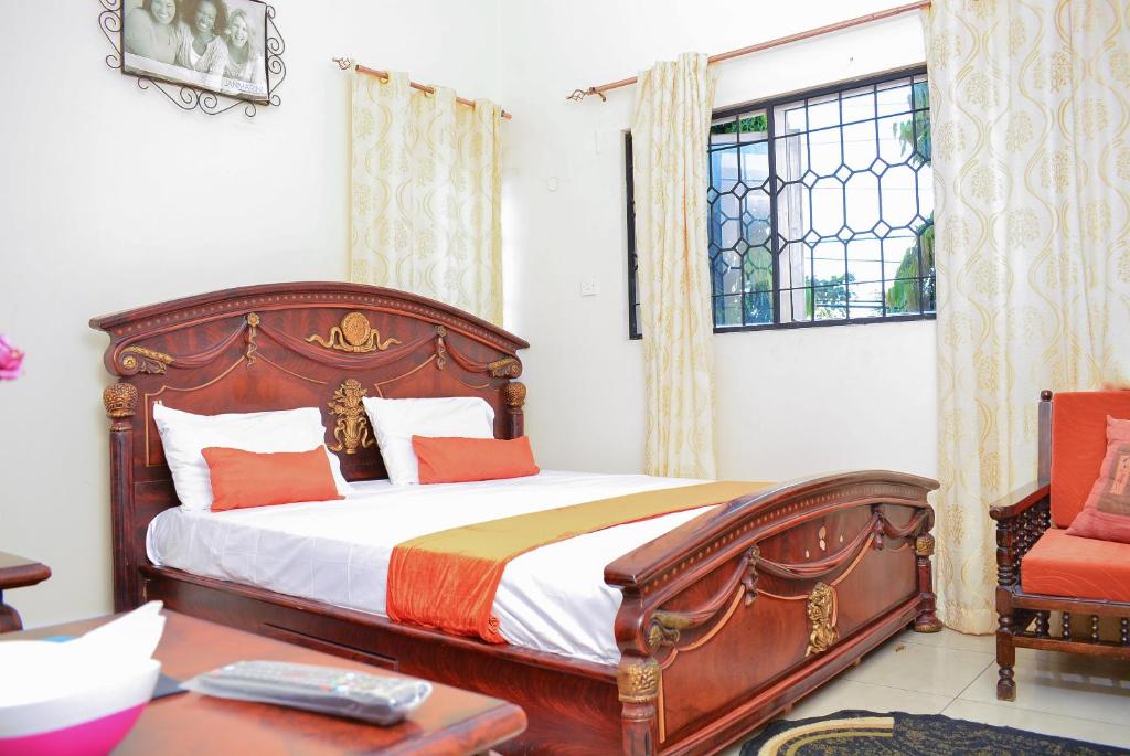 a bedroom with a large bed and a window at TEVAH SUITES in Mombasa