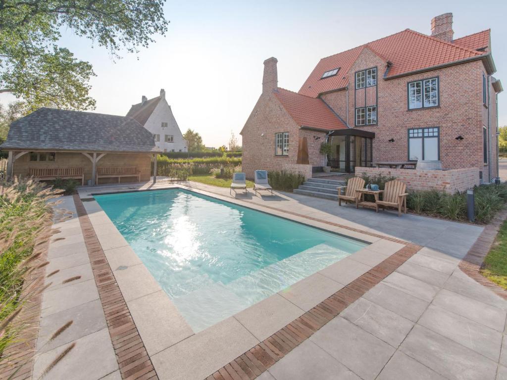 a swimming pool in front of a house at Villa Villa Sas by Interhome in Oudenburg