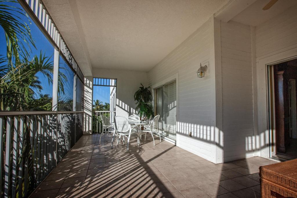 a balcony with chairs and a table on a house at Olde Marco Island Inn and Suites in Marco Island