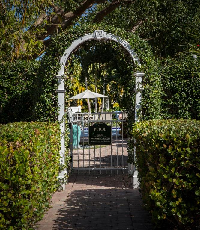an entrance to a garden with an archway at Olde Marco Island Inn and Suites in Marco Island