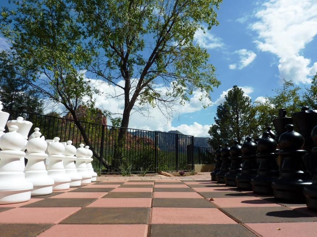 a chess board with white vases on a sidewalk at Cedars Resort in Sedona