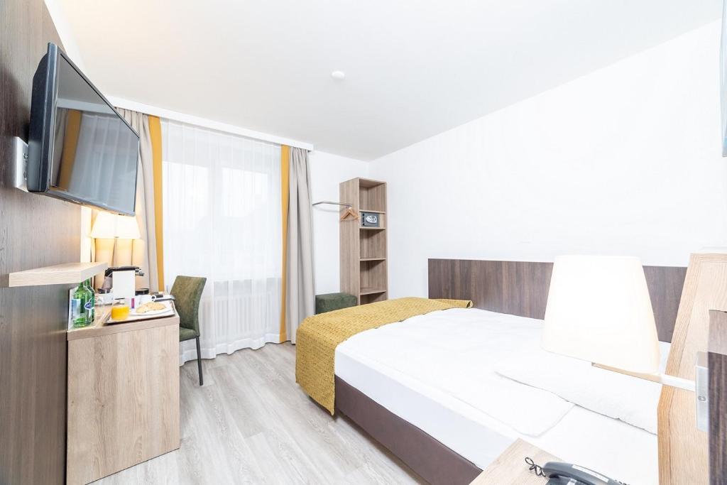 Postel nebo postele na pokoji v ubytování Hotel Alfa