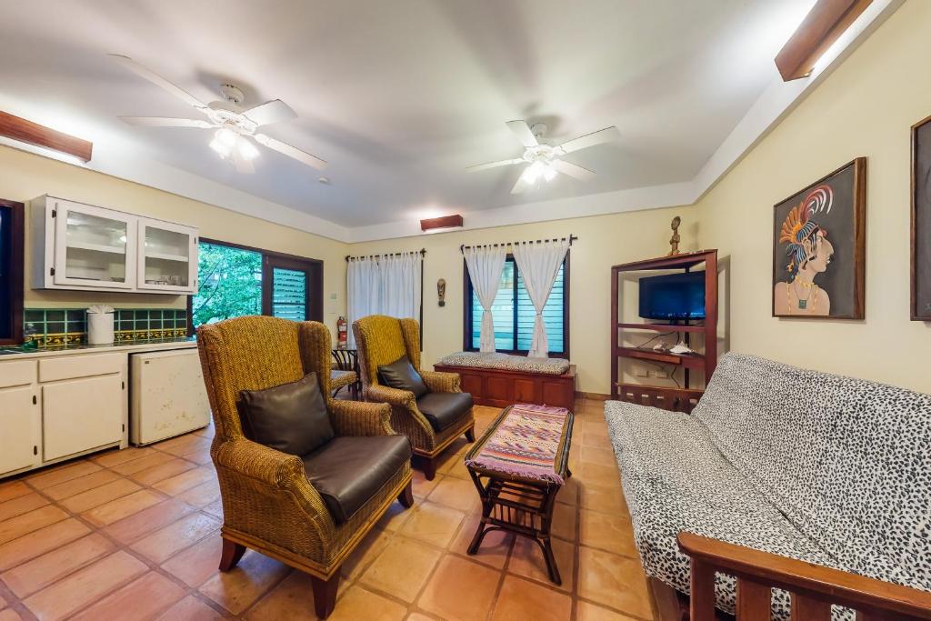 a living room with a couch and chairs at Beachside Villas Gold Standard Certified in Placencia Village