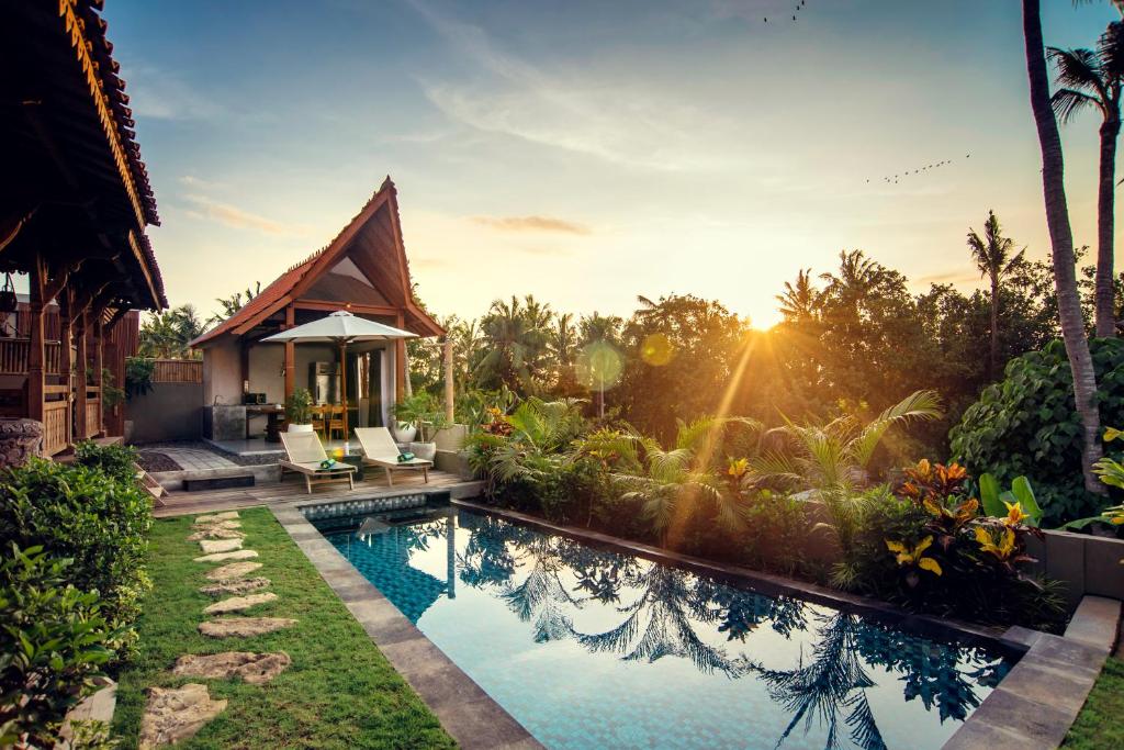 a villa with a swimming pool in a resort at PNB Bali Villas in Canggu
