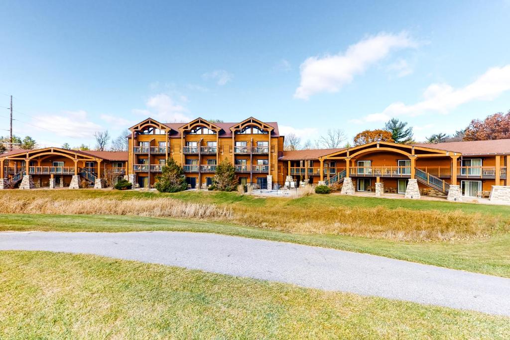 a large apartment building with a road in front at Chula Vista Villas in Wisconsin Dells