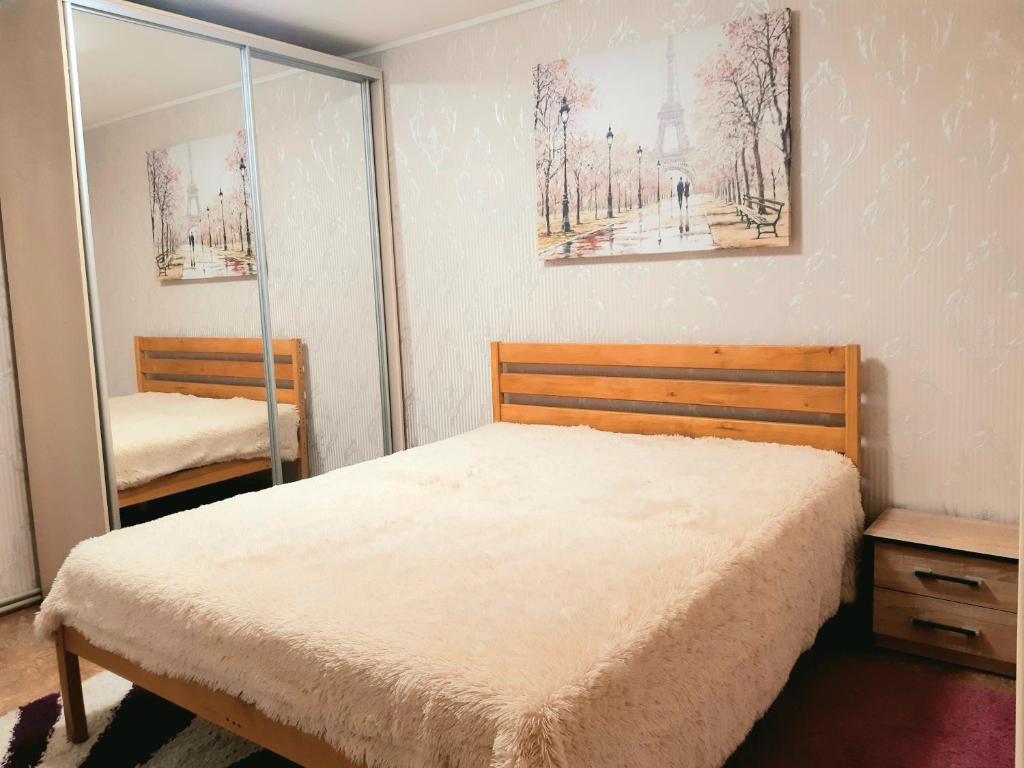 a bedroom with a bed and a mirror at Шевченко 2 in Kropyvnytskyi