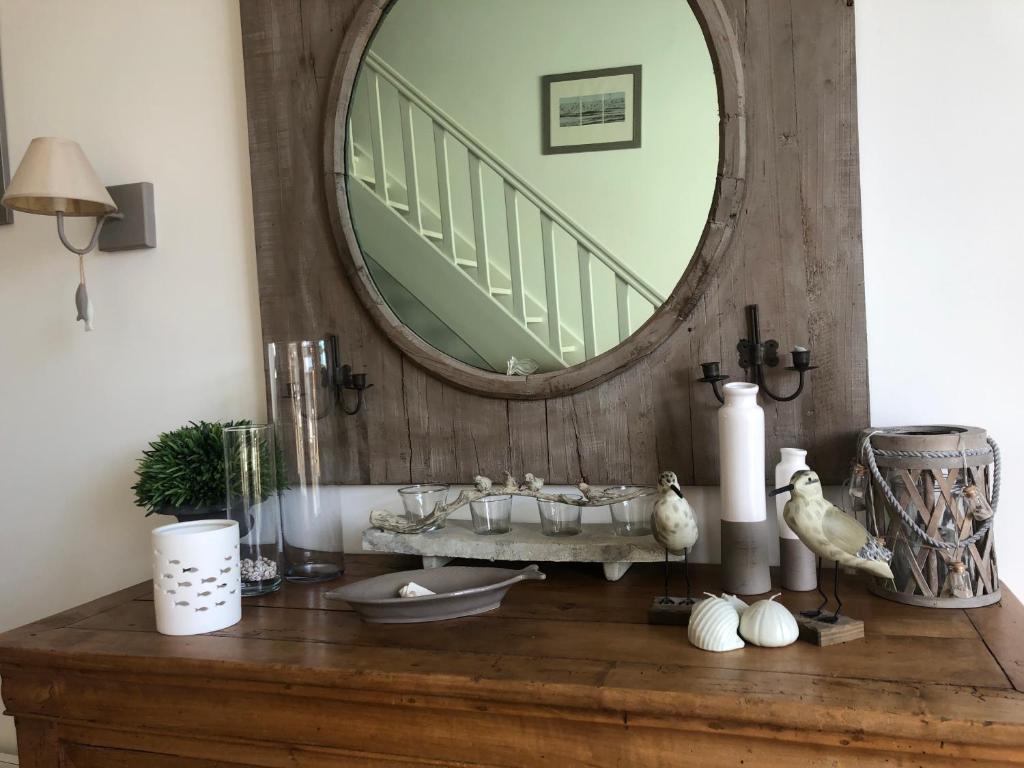 a bathroom with a vanity with a mirror and a sink at Villa Pigouille in Sainte-Marie-de-Ré