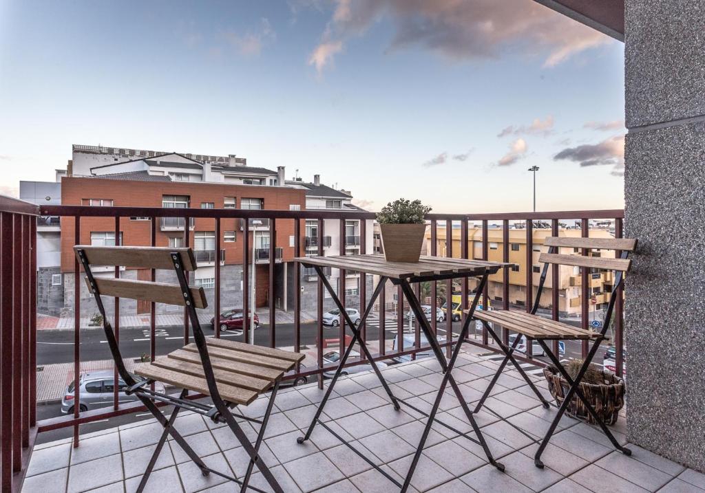 a balcony with a table and chairs on a balcony at New and modern apartment in Salinetas beach. in Salinetas