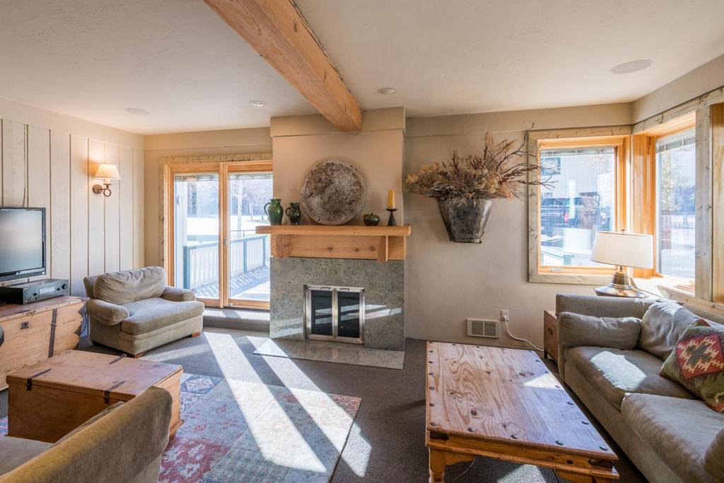 a living room with a couch and a fireplace at Prospector 134 in Ketchum