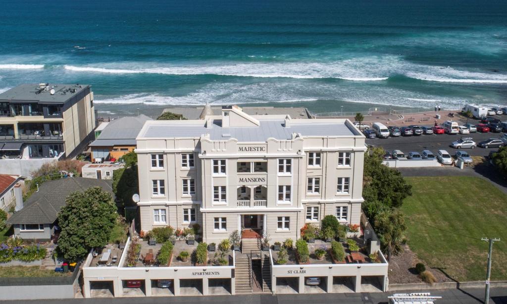 an aerial view of a white building with the ocean at Majestic Mansions – Apartments at St Clair in Dunedin