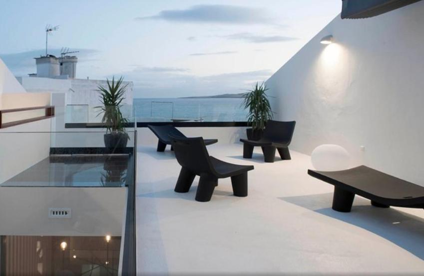 a balcony with benches and a view of the ocean at Ocean Space Lanzarote in Punta de Mujeres