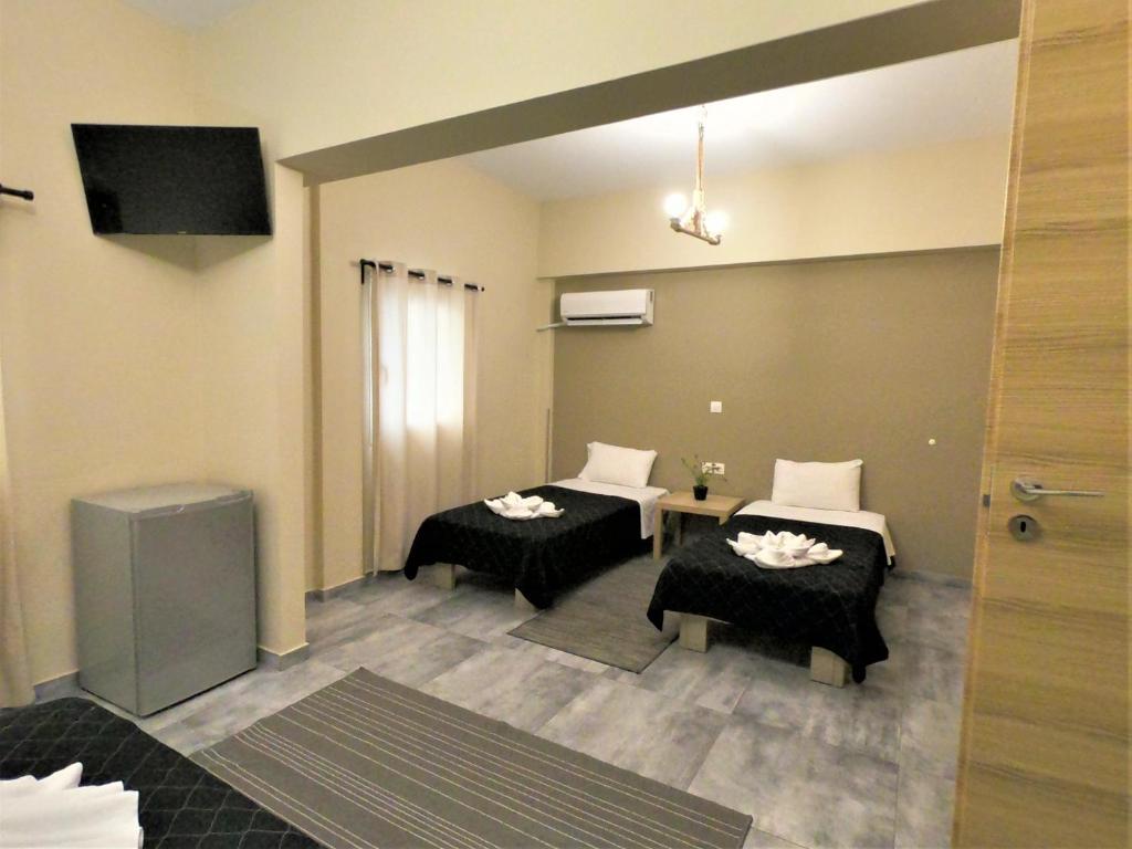 Postel nebo postele na pokoji v ubytování Achillion Hotel Piraeus