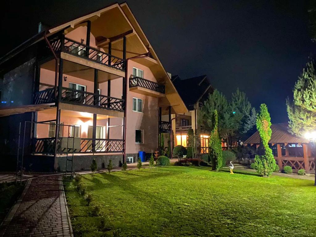 a large building with a green lawn in front of it at U Neli in Solochin