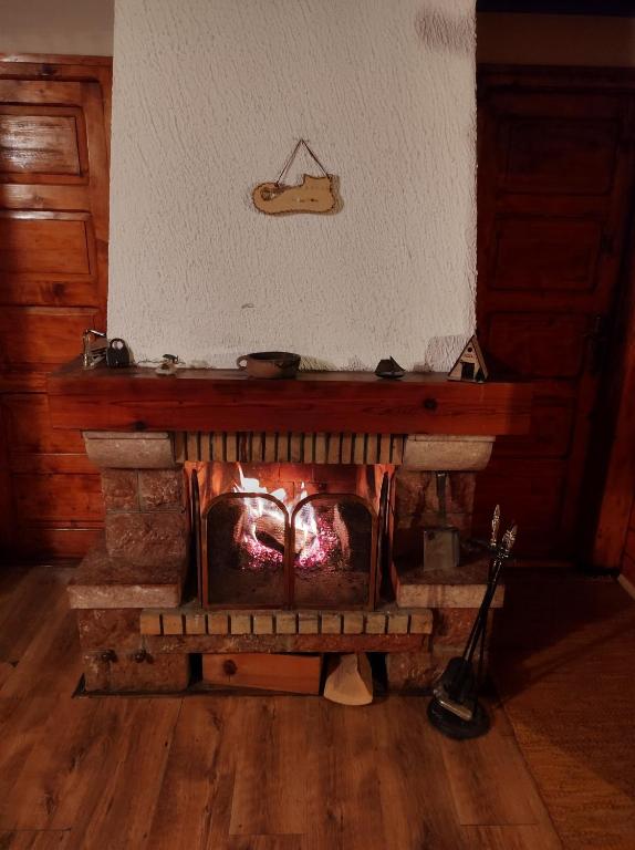 a brick fireplace in a living room with at Brvnara Maljkovic Drina 