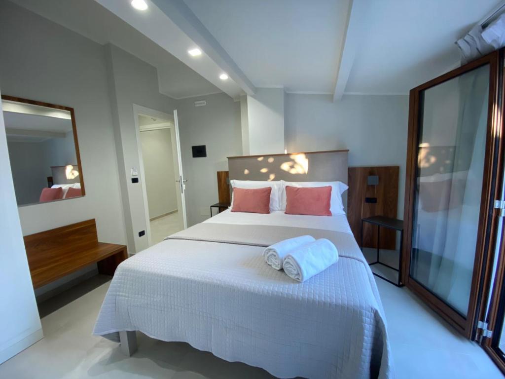 a bedroom with a large bed with two towels on it at Villa Antonino in Giardini Naxos