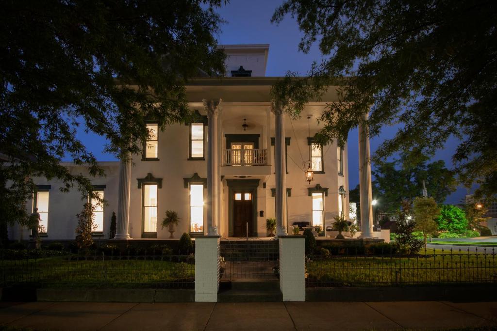 a large white house with a front porch at night at Belle Louise Historic Bed & Breakfast in Paducah
