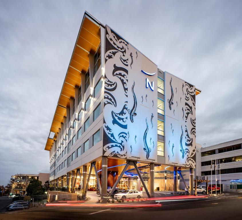 a building with a painting on the side of it at Novotel Tainui Hamilton in Hamilton
