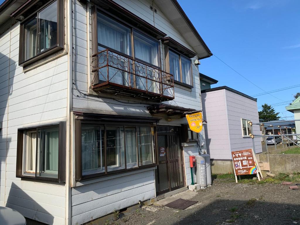un edificio con un balcón en el lateral. en Guesthouse TOMAYA, en Nemuro