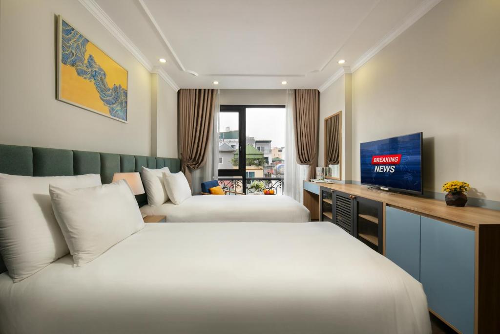 Postel nebo postele na pokoji v ubytování C'Bon Hotel Do Quang