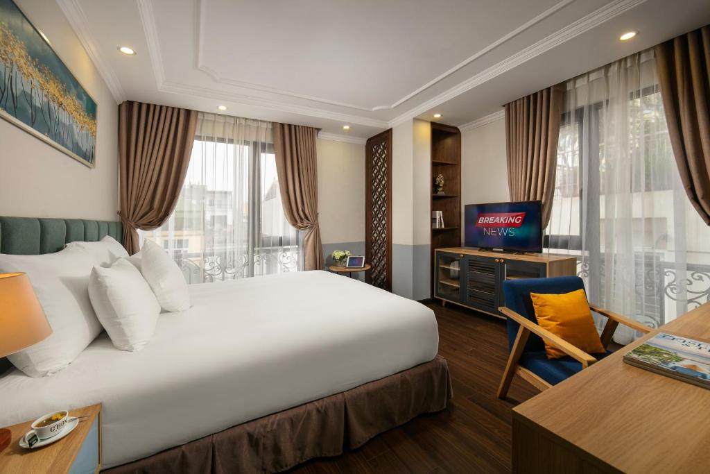 Postel nebo postele na pokoji v ubytování C'Bon Hotel Do Quang
